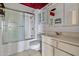Cozy bathroom featuring a shower with sliding doors and a white cabinet at 10072 W Lancaster Dr, Sun City, AZ 85351