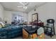 Cluttered bedroom with a ceiling fan and sliding glass doors providing access to the patio at 10072 W Lancaster Dr, Sun City, AZ 85351