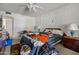 Untidy bedroom, featuring a bed, desk, and dresser with personal items scattered throughout the space at 10072 W Lancaster Dr, Sun City, AZ 85351