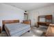 Bright bedroom with a queen-sized bed, desk, and storage unit, ready for personalization at 10072 W Lancaster Dr, Sun City, AZ 85351