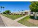Pleasant street view showcasing multiple homes with well-kept lawns and mature trees at 10072 W Lancaster Dr, Sun City, AZ 85351