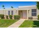 Charming home featuring a walkway to the front door, complemented by green grass and small bushes at 10072 W Lancaster Dr, Sun City, AZ 85351