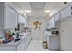 Functional kitchen with white cabinets, tile floors, and ample countertop space at 10072 W Lancaster Dr, Sun City, AZ 85351
