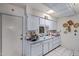 Kitchen featuring white cabinets and tile floors, offering plenty of storage and countertop area at 10072 W Lancaster Dr, Sun City, AZ 85351