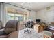 Relaxing living room featuring tile flooring and access to the patio area at 10072 W Lancaster Dr, Sun City, AZ 85351