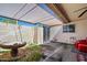 Covered patio featuring a garden area and access to the yard at 10072 W Lancaster Dr, Sun City, AZ 85351