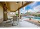 Covered back patio with outdoor seating overlooking the fenced pool area at 10242 E Pantera Ave, Mesa, AZ 85212