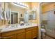 Bathroom with double sinks, framed mirrors and tiled floors at 10242 E Pantera Ave, Mesa, AZ 85212