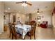 Open-concept dining room flows into the living room and laundry area, with matching tile flooring at 10242 E Pantera Ave, Mesa, AZ 85212