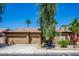 Charming single-story home featuring a three-car garage and mature desert landscaping at 10242 E Pantera Ave, Mesa, AZ 85212