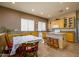 Bright kitchen with ample countertop space, light wood cabinetry, and tile flooring at 10242 E Pantera Ave, Mesa, AZ 85212