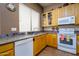Well-lit kitchen featuring granite countertops, tile backsplash, stainless steel sink, and wood cabinets at 10242 E Pantera Ave, Mesa, AZ 85212