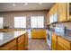 Well-lit kitchen with a center island, tile floors, and ample counter space for cooking at 10242 E Pantera Ave, Mesa, AZ 85212