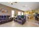 Open-concept living space with kitchen access, tile floors, and multiple seating areas at 10242 E Pantera Ave, Mesa, AZ 85212