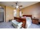 Comfortable main bedroom with carpet flooring, ceiling fan, and natural light at 10242 E Pantera Ave, Mesa, AZ 85212