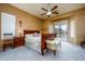 Spacious main bedroom with carpet flooring, ceiling fan, and sliding glass doors leading to the backyard at 10242 E Pantera Ave, Mesa, AZ 85212