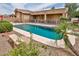 Backyard pool with safety fence, adjacent to covered patio and garden at 10242 E Pantera Ave, Mesa, AZ 85212