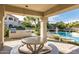 Inviting outdoor patio featuring a picnic table and built-in BBQ grills adjacent to the pool at 10401 N 52Nd St # 210, Paradise Valley, AZ 85253
