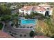Aerial view of the pool area with seating and umbrellas surrounded by mature landscaping at 10401 N 52Nd St # 210, Paradise Valley, AZ 85253