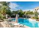 Beautiful community pool surrounded by lush landscaping, lounge chairs, and inviting tables and chairs at 10401 N 52Nd St # 210, Paradise Valley, AZ 85253