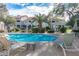 Stunning pool view surrounded by palm trees and well-maintained landscaping, offering a tropical oasis feel at 10401 N 52Nd St # 210, Paradise Valley, AZ 85253