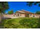 Wide backyard with green lawn, low-maintenance landscaping, and block fence at 1071 E Chelsea Dr, San Tan Valley, AZ 85140