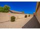 The backyard features rock landscaping with block walls, and mature trees at 1071 E Chelsea Dr, San Tan Valley, AZ 85140