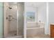 Bright bathroom featuring a bathtub and a standing shower at 1071 E Chelsea Dr, San Tan Valley, AZ 85140