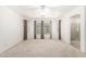 Bright main bedroom with carpet, large window and adjoining bathroom with standing shower at 1071 E Chelsea Dr, San Tan Valley, AZ 85140