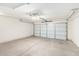 Clean, empty two car garage with overhead lighting and an automatic door at 1071 E Chelsea Dr, San Tan Valley, AZ 85140