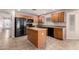 Updated kitchen with island, tile flooring, and ample storage with modern black appliances at 1071 E Chelsea Dr, San Tan Valley, AZ 85140