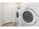 Laundry room with a side-by-side washer and dryer, plus overhead storage at 1071 E Chelsea Dr, San Tan Valley, AZ 85140
