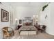 Bright bedroom boasts large windows, patterned bedding, and stylish seating with a charming and airy feel at 10869 E Hedgehog Pl, Scottsdale, AZ 85262