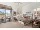 Bright bedroom with a patterned bedspread, sliding glass doors to an outdoor patio, and white walls at 10869 E Hedgehog Pl, Scottsdale, AZ 85262