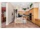 Kitchen with wooden cabinetry, granite countertop island, tile flooring, and eat in breakfast bar at 10869 E Hedgehog Pl, Scottsdale, AZ 85262