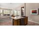 Bright kitchen island features granite counters and a sink, with a comfortable living room in the background at 10869 E Hedgehog Pl, Scottsdale, AZ 85262