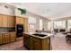 Kitchen with wooden cabinets, granite countertops, stainless steel appliances and an island with double sink at 10869 E Hedgehog Pl, Scottsdale, AZ 85262