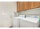 Bright laundry room with stacked washer and dryer at 10869 E Hedgehog Pl, Scottsdale, AZ 85262