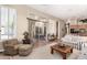 Living room featuring neutral colors, natural light, and seating with access to outdoor patio at 10869 E Hedgehog Pl, Scottsdale, AZ 85262