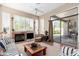 Living room featuring fireplace, neutral colors, and seating with access to outdoor pool area at 10869 E Hedgehog Pl, Scottsdale, AZ 85262