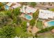 Aerial shot showcasing a private backyard oasis with a sparkling pool, lush greenery, and a charming play area at 11051 N 45Th Pl, Phoenix, AZ 85028