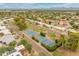 Expansive aerial view showcases tennis courts amid mature landscaping, tree lined streets, and homes at 11051 N 45Th Pl, Phoenix, AZ 85028