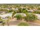 Aerial view of a well-manicured property with lush landscaping, mature trees, and a charming residence at 11051 N 45Th Pl, Phoenix, AZ 85028