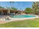 Lush backyard features a sparkling pool, covered patio, and mature landscaping offering privacy and relaxation at 11051 N 45Th Pl, Phoenix, AZ 85028