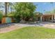An expansive backyard featuring a picnic table, pool, mature trees, and outdoor seating area at 11051 N 45Th Pl, Phoenix, AZ 85028