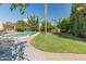 This serene backyard showcases a pool, mature trees, and a well-maintained lawn for outdoor enjoyment at 11051 N 45Th Pl, Phoenix, AZ 85028