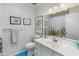 Bright bathroom features a white single sink vanity with framed art and colorful shower curtain at 11051 N 45Th Pl, Phoenix, AZ 85028