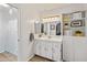 This light and bright bathroom features a vanity with storage and a framed mirror at 11051 N 45Th Pl, Phoenix, AZ 85028