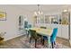 Charming dining room with colorful decor, modern light fixture, and arched window at 11051 N 45Th Pl, Phoenix, AZ 85028