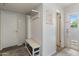 Inviting entryway features a coat rack with built-in storage bench and nearby exterior entry at 11051 N 45Th Pl, Phoenix, AZ 85028
